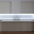 luxury-led-kitchen-light-design-mixed-with-white-counter-table-over-brown-laminate-floor
